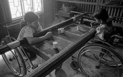 Two physically challenged girls engaged in embroidery on clothes at The Centre for the Rehabilitation of the Paralysed, CRP at Savar, Dhaka, Bangladesh, 2005 by Unbekannt Unbekannt